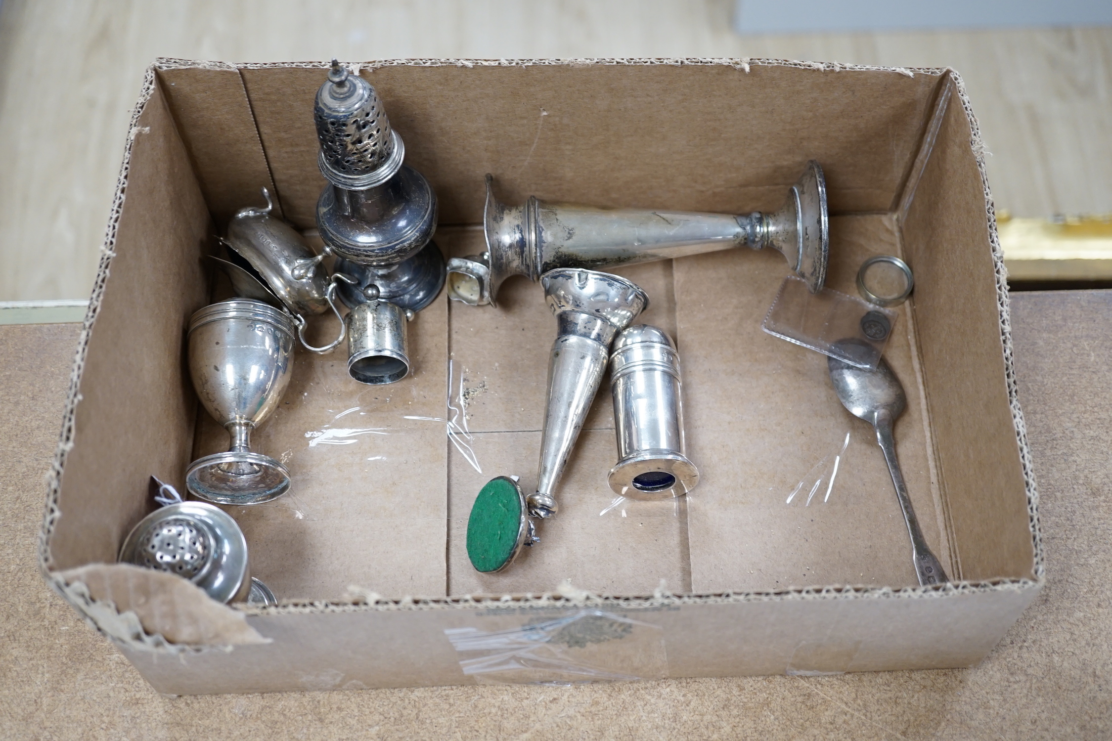 A quantity of silver items including a late Victorian repousse photograph frame, William Comyns, London, 1899, 20cm, three Georgian pepperettes, pair of small Armada dishes, quaich, vest case, menu holder, basting spoons